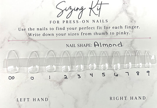 Astral Hue Sizing Kit for press-on nails. A white marble-patterned card featuring 11 clear Après Gel-X almond-shaped nail tips labeled 00 through 9. Includes instructions to find the perfect fit and spaces to write down sizes for the left and right hands.