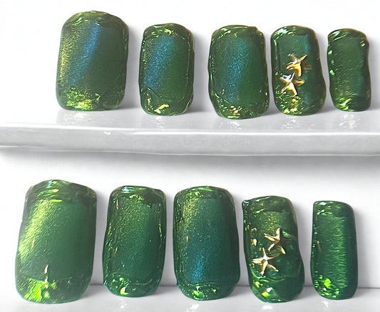Emerald Abyss press-on nails featuring a deep green jelly base with a magnetic cat-eye shimmer. The design includes reflective mirror gold chrome accents and a high-gloss finish on a square shape.