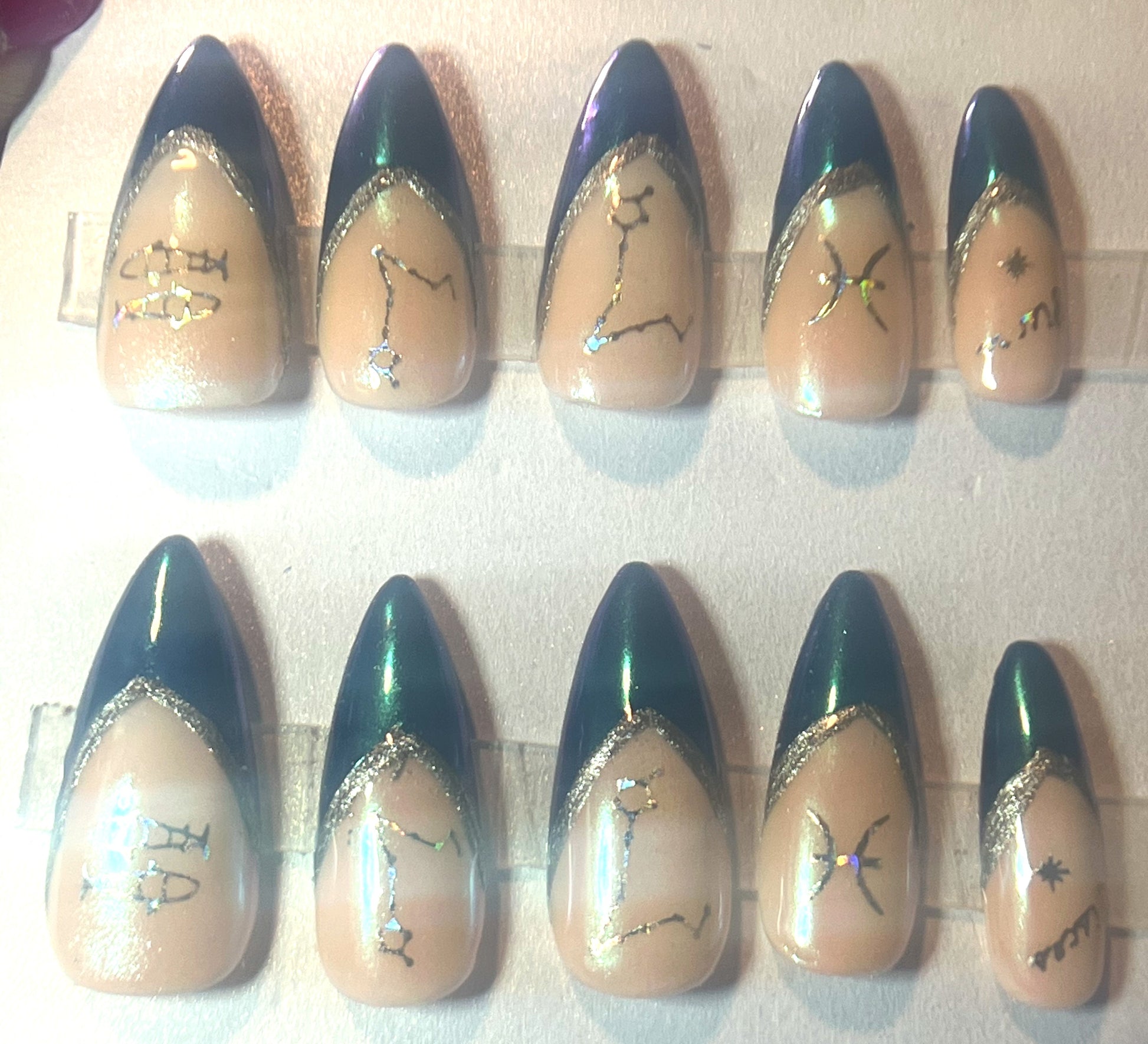 Pisces zodiac press-on nails with an all-over mermaid chrome iridescent finish. The design features a nude base and blue French tips, both covered in a pearlescent shimmer with silver holographic accents. Stiletto shape.